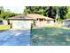 Charming single-story home featuring a well-maintained lawn, attached two car garage and a welcoming front entrance at 5263 Nw 62Nd Nw Ave, Ocala, FL 34482