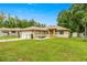Charming single story home featuring a fenced front yard, attached garage, and a welcoming front sitting area at 5263 Nw 62Nd Nw Ave, Ocala, FL 34482