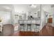 Kitchen featuring bar seating, white cabinetry, view to dining room, and hardwood flooring at 5263 Nw 62Nd Nw Ave, Ocala, FL 34482