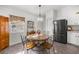 Bright kitchen featuring white cabinetry, stainless steel appliances, stone flooring, and dining table at 5263 Nw 62Nd Nw Ave, Ocala, FL 34482