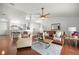 Open-concept living room featuring hardwood floors, seating, and a view of the kitchen with bar seating at 5263 Nw 62Nd Nw Ave, Ocala, FL 34482