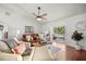 Cozy living room showcasing hardwood floors, comfortable seating, and natural light from sliding glass doors at 5263 Nw 62Nd Nw Ave, Ocala, FL 34482