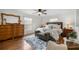 Bright main bedroom featuring a cozy bed, a dresser, and natural light from the windows at 5263 Nw 62Nd Nw Ave, Ocala, FL 34482