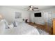 Well-lit main bedroom featuring a comfortable bed, side tables, and a doorway to the bathroom at 5263 Nw 62Nd Nw Ave, Ocala, FL 34482