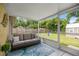 Relaxing screened patio with comfortable seating and view of the backyard's green space at 5263 Nw 62Nd Nw Ave, Ocala, FL 34482