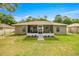 Wide shot of the home's screened in porch, showcasing the backyard and pathway to the entry at 5263 Nw 62Nd Nw Ave, Ocala, FL 34482