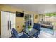 View of the screened porch featuring a sitting area and a mounted TV for outdoor entertainment at 5263 Nw 62Nd Nw Ave, Ocala, FL 34482