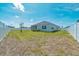 Expansive backyard with a well-maintained lawn, white vinyl fence, and a screened-in patio for entertaining at 5621 Sw 90Th Ln, Ocala, FL 34476
