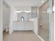 Modern bathroom with dual sinks, neutral stone countertops, and a glass shower enclosure at 5621 Sw 90Th Ln, Ocala, FL 34476
