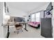 Bright flex room includes neutral decor, a futon, desk, and monitor setup at 5621 Sw 90Th Ln, Ocala, FL 34476