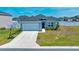 Charming single-story home with a well-maintained lawn and attached two-car garage and a basketball hoop at 5621 Sw 90Th Ln, Ocala, FL 34476