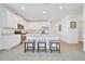 Bright open kitchen featuring white cabinets, stainless steel appliances, and a large island with seating at 5621 Sw 90Th Ln, Ocala, FL 34476