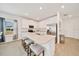 Modern kitchen with white cabinets, stainless steel appliances, stone countertops, and seating at the island at 5621 Sw 90Th Ln, Ocala, FL 34476