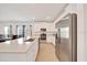 Well-lit kitchen with stainless appliances, a quartz island, ample counter space, and open to the dining area at 5621 Sw 90Th Ln, Ocala, FL 34476