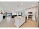 Open concept living space featuring a modern kitchen with island and stainless steel appliances at 5621 Sw 90Th Ln, Ocala, FL 34476