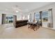 Open-concept living room with a large sofa, dining area, and natural light at 5621 Sw 90Th Ln, Ocala, FL 34476