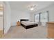 A carpeted main bedroom has a ceiling fan and a bed in the center at 5621 Sw 90Th Ln, Ocala, FL 34476