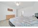 Main bedroom features a ceiling fan, a black platform bed, and light wood furniture at 5621 Sw 90Th Ln, Ocala, FL 34476