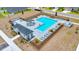 Aerial view of community pool featuring sun loungers, seating, open air covered patio and a pool house at 5621 Sw 90Th Ln, Ocala, FL 34476