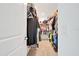 A walk-in closet with racks of clothing and a glimpse of stacked storage containers at 5621 Sw 90Th Ln, Ocala, FL 34476