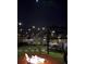 Tranquil backyard at night with string lights, a fire pit, gazebo, and outdoor seating, creating a serene ambiance for relaxation at 5667 Sw 92Nd Pl, Ocala, FL 34476