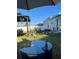 Inviting backyard oasis featuring a gazebo, patio furniture, string lights, and a well-manicured lawn perfect for relaxation at 5667 Sw 92Nd Pl, Ocala, FL 34476