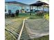 Relaxing backyard with a hammock, gazebo, fire pit, and lush green lawn, perfect for outdoor living and entertaining at 5667 Sw 92Nd Pl, Ocala, FL 34476