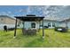 Expansive backyard with a gazebo, dining table, outdoor seating, and a grill, creating an ideal space for outdoor gatherings at 5667 Sw 92Nd Pl, Ocala, FL 34476