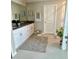 A bathroom featuring double vanity, granite countertop and neutral-toned walls at 5667 Sw 92Nd Pl, Ocala, FL 34476