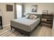 Comfortable bedroom featuring carpet, modern bedding, and an entertainment center, offering a relaxing retreat at 5667 Sw 92Nd Pl, Ocala, FL 34476