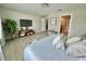 Bedroom featuring light wood floors, neutral-toned walls, and a view of the en-suite bathroom at 5667 Sw 92Nd Pl, Ocala, FL 34476
