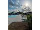 Community pool featuring lounge chairs and manicured landscaping under a sunny sky at 5667 Sw 92Nd Pl, Ocala, FL 34476