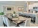 Elegant dining area featuring a stylish table setting, modern decor, and a seamless connection to the kitchen at 5667 Sw 92Nd Pl, Ocala, FL 34476