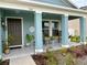 Inviting covered front porch with seating, decor, and a tiled floor, perfect for relaxing outdoors at 5667 Sw 92Nd Pl, Ocala, FL 34476
