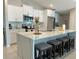 Modern kitchen featuring an island with seating, white cabinetry and stainless steel appliances at 5667 Sw 92Nd Pl, Ocala, FL 34476
