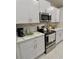 Modern kitchen with white cabinets, stainless steel appliances, and a view of the countertop at 5667 Sw 92Nd Pl, Ocala, FL 34476