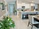 A view of the kitchen, open to the Gathering room, featuring white cabinets and marble countertops at 5667 Sw 92Nd Pl, Ocala, FL 34476