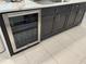 Kitchen with black cabinets, stainless steel wine fridge and white countertop at 5667 Sw 92Nd Pl, Ocala, FL 34476