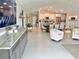 Open concept living room with gray cabinets, tile floors, and eat in kitchen at 5667 Sw 92Nd Pl, Ocala, FL 34476