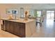 Open concept living room with marble island, dining area, and view of the backyard at 5667 Sw 92Nd Pl, Ocala, FL 34476