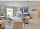 Bright living room with neutral colors, hardwood floors and large TV at 5667 Sw 92Nd Pl, Ocala, FL 34476