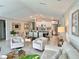 Open-concept living area featuring stylish furnishings, a view of the dining space, and abundant natural light at 5667 Sw 92Nd Pl, Ocala, FL 34476