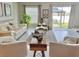 Bright and airy living room with comfortable seating, stylish decor, and access to the outdoor patio area at 5667 Sw 92Nd Pl, Ocala, FL 34476