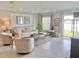 Cozy living room with comfortable seating, natural light, and access to the patio, perfect for relaxation at 5667 Sw 92Nd Pl, Ocala, FL 34476