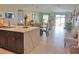 Open concept living room with marble island, dining area, and view of the backyard at 5667 Sw 92Nd Pl, Ocala, FL 34476