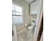 A small toilet room with a window and a wooden decor sign at 5667 Sw 92Nd Pl, Ocala, FL 34476
