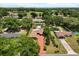 Beautiful aerial view of the house, mature trees, expansive lawn and sparkling pool in a desirable neighborhood at 6157 Ne 25Th Ave, Ocala, FL 34479