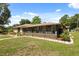 Spacious backyard with a screened-in patio, garden, and lush green lawn at 6157 Ne 25Th Ave, Ocala, FL 34479