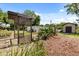 Charming backyard with a pergola, lush greenery, privacy fence, and a convenient storage shed at 6157 Ne 25Th Ave, Ocala, FL 34479