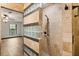 A modern bathroom features a step-in shower with glass block and stone tile surround at 6157 Ne 25Th Ave, Ocala, FL 34479